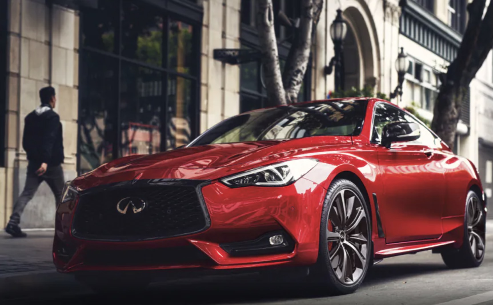 A red 2021 Infiniti Q60 parked on the sidewalk