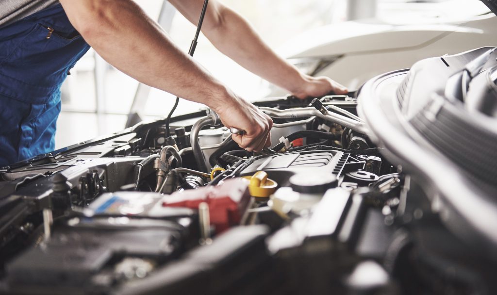 Mechanic working on a car engine during vehicle service