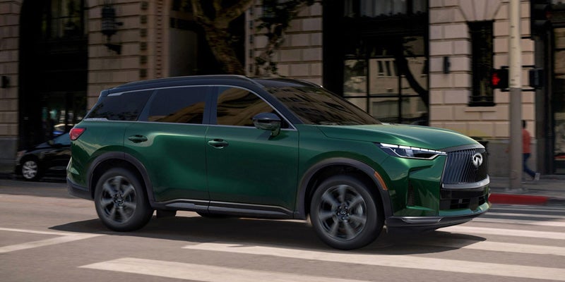 2026 INFINITI QX60 compact crossover SUV, featuring a refined exterior and spacious interior, displayed in an urban setting.