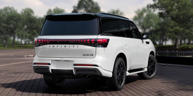 Rear view of a white QX80 showcasing its sleek design and distinctive taillights.